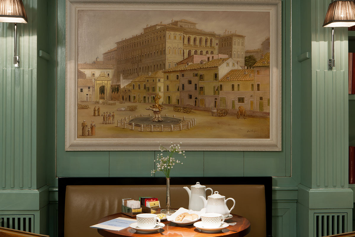 Breakfast nook with a painting hanging on mint green walls at Hotel Stendhal 